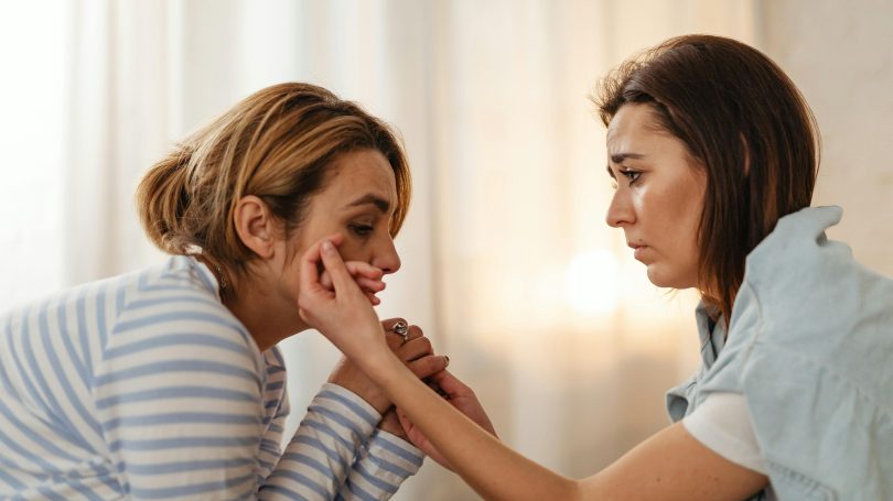 A concerned woman comforting a distressed friend